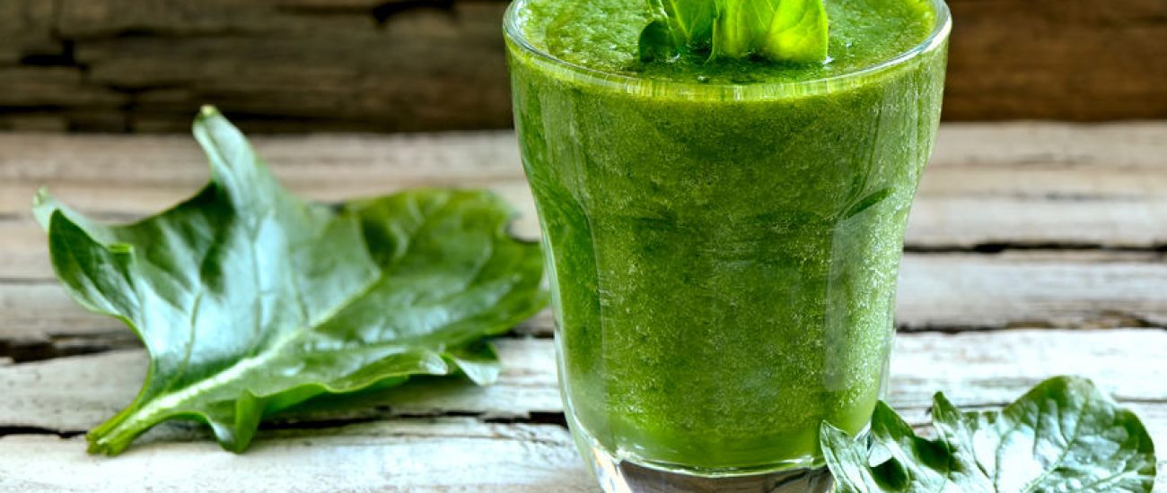 36904200 - green spinach smoothie in a glass with fresh leaves